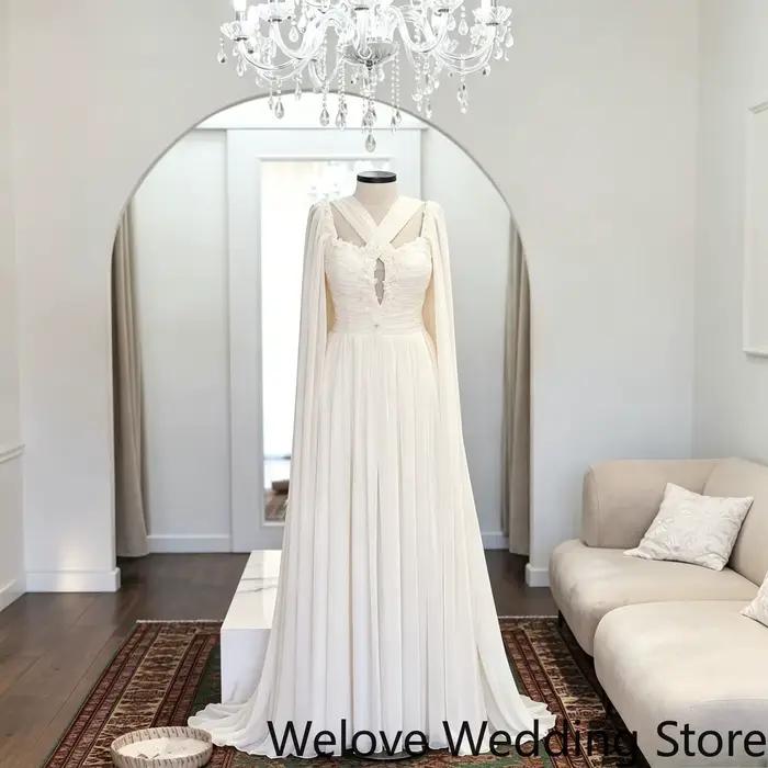 Robe de mariée avec encolure halter croisée effet cache-cœur, découpe centrale en forme de clé, cors