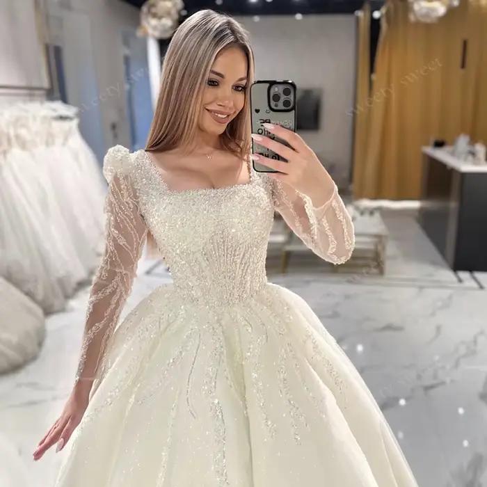Robe de Mariée ShaLaYIi Trapèze Luxe Brodée Perles Manches Longues Col Carré Train Couronne Occasions Spéciales
